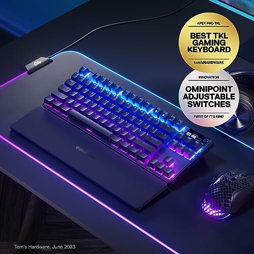 RGB gaming keyboard and mouse on desk with award badges