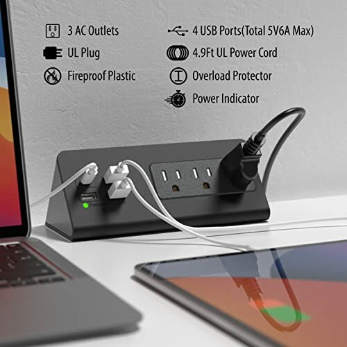 Black power strip with USB ports and AC outlets on desk